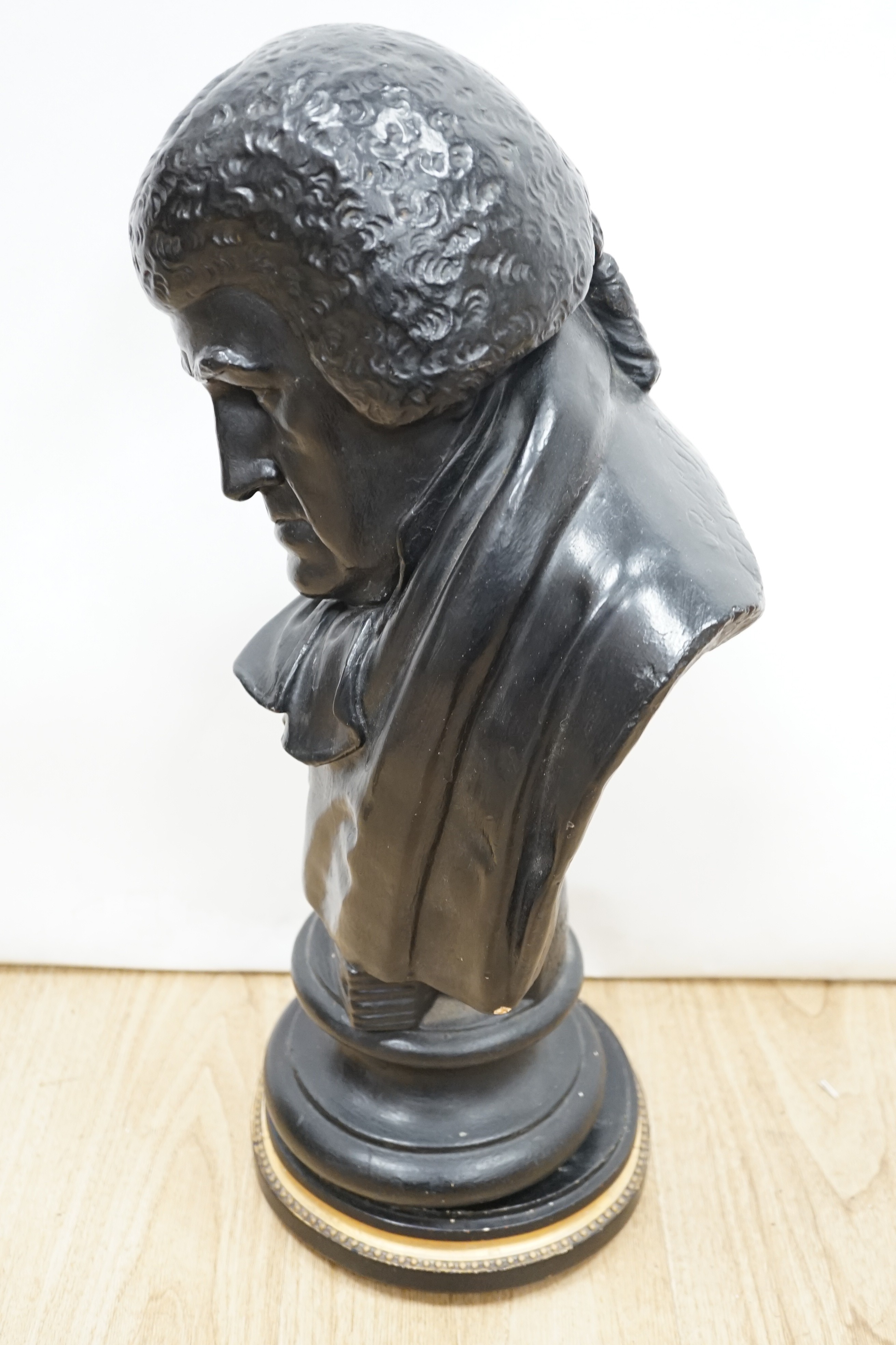 A black painted plaster bust of a judge, inscribed 1826, 49cms high.